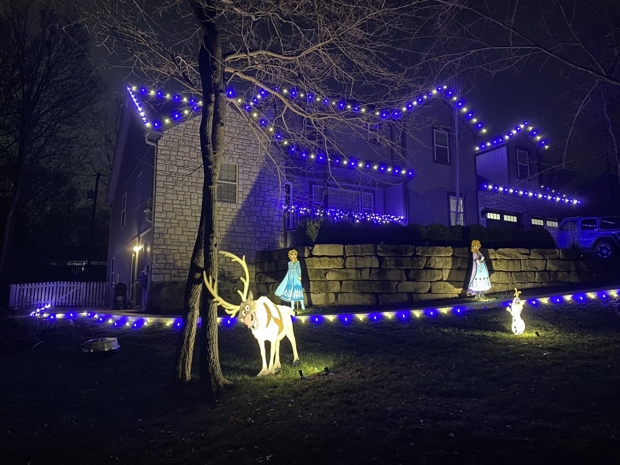 Colorful blue and white holiday lighting on a home